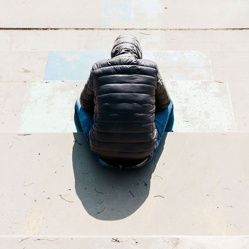 Ryggen af en person med hætten over hovedet