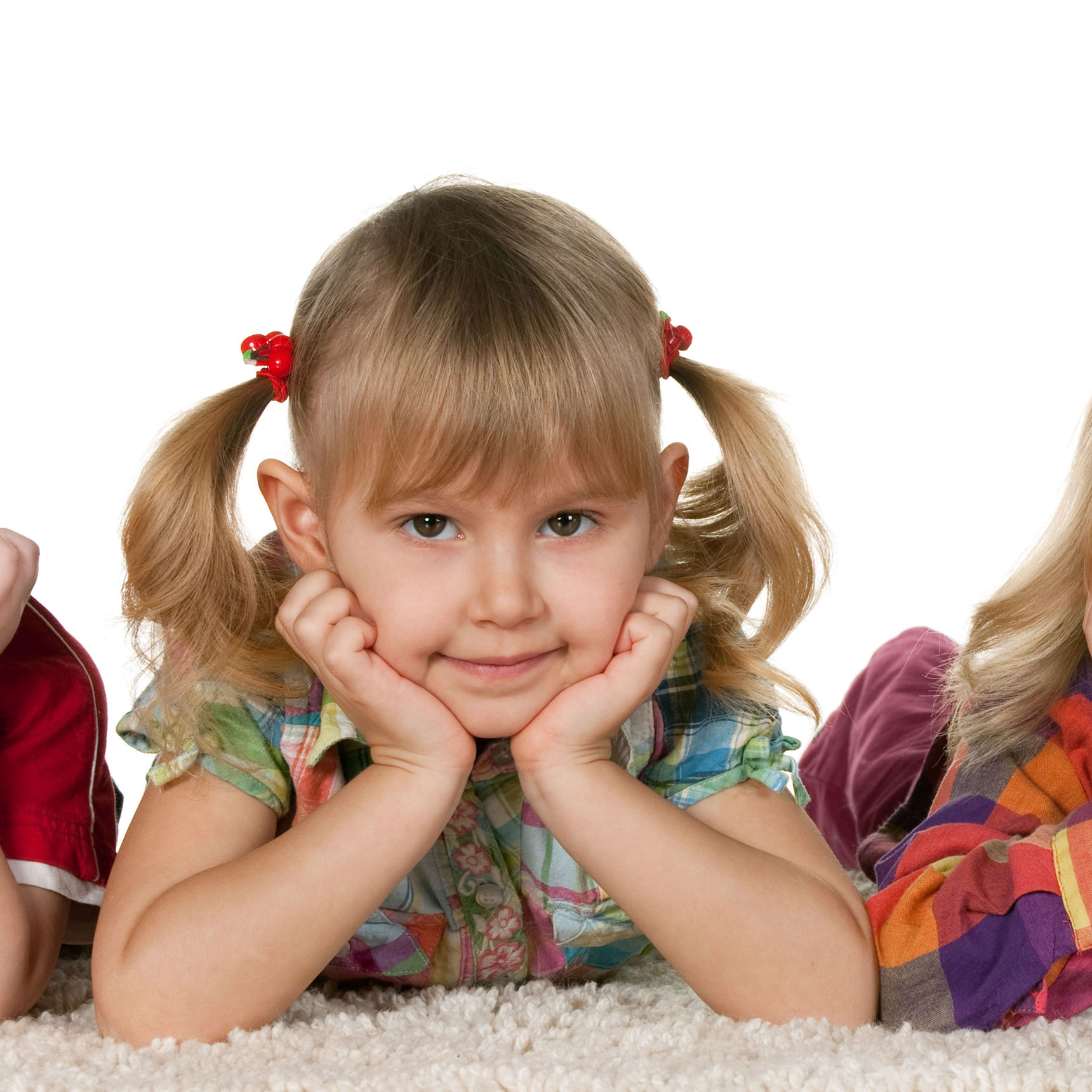 Mindre børn der ligger på maven med hænderne under hovedet